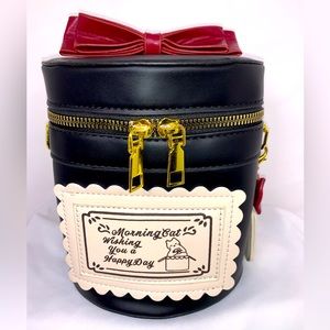 Black trunk style crossbody handbag.